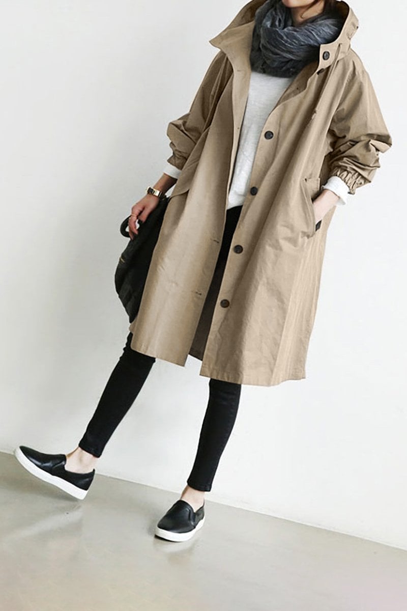 Detail of lightweight waterproof fabric on a women's stylish hooded rain trench coat. Wet weather ready.