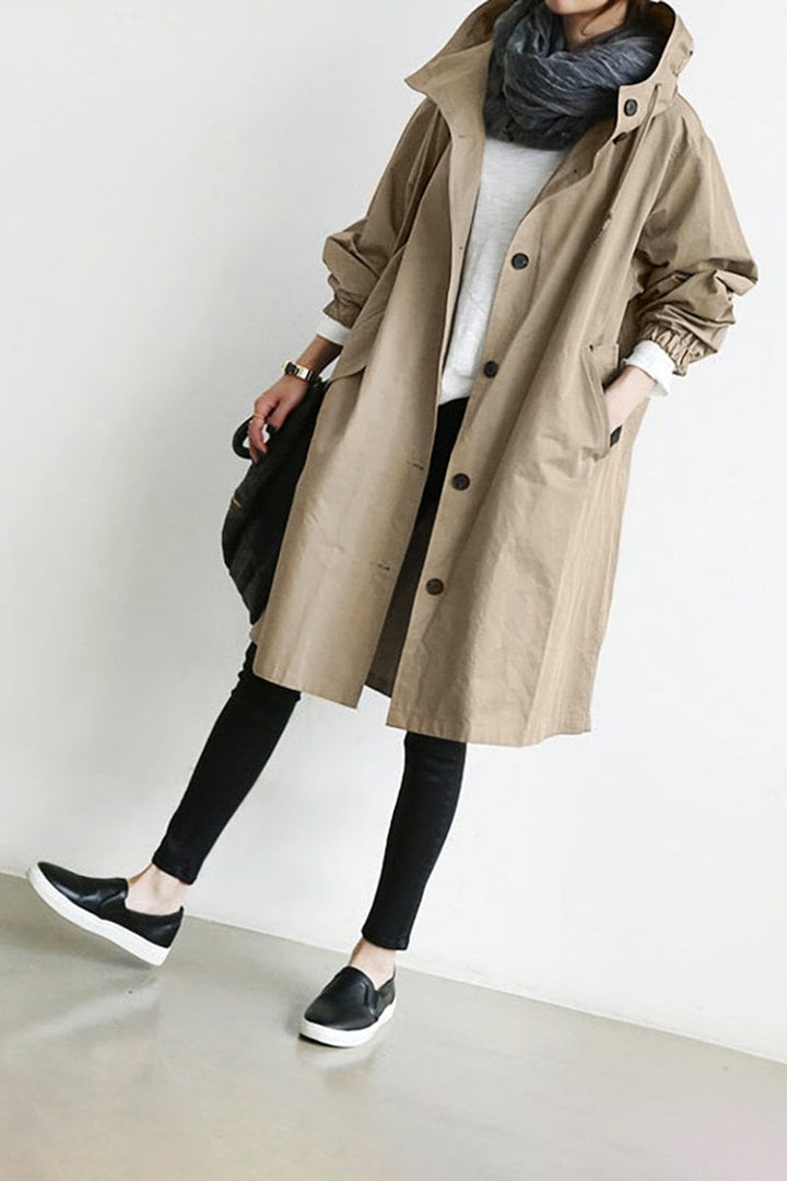 Detail of lightweight waterproof fabric on a women's stylish hooded rain trench coat. Wet weather ready.