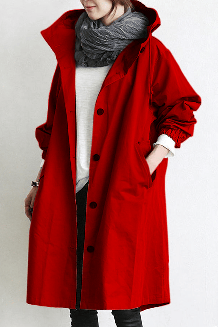 Women's lightweight waterproof trench coat, neatly folded for travel. Stylish hooded raincoat.