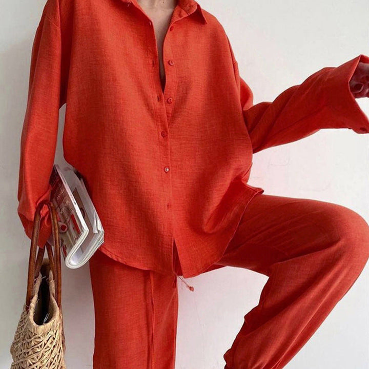 Coordinated women's fashion set featuring a stylish blouse & relaxed wide-leg pants. Versatile summer two-piece outfit.