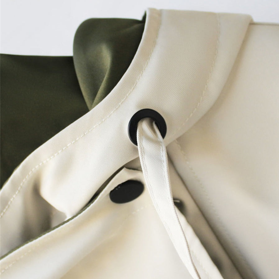 Weatherproof women's rain jacket, waterproof and hooded, ideal lightweight outerwear for protection.
