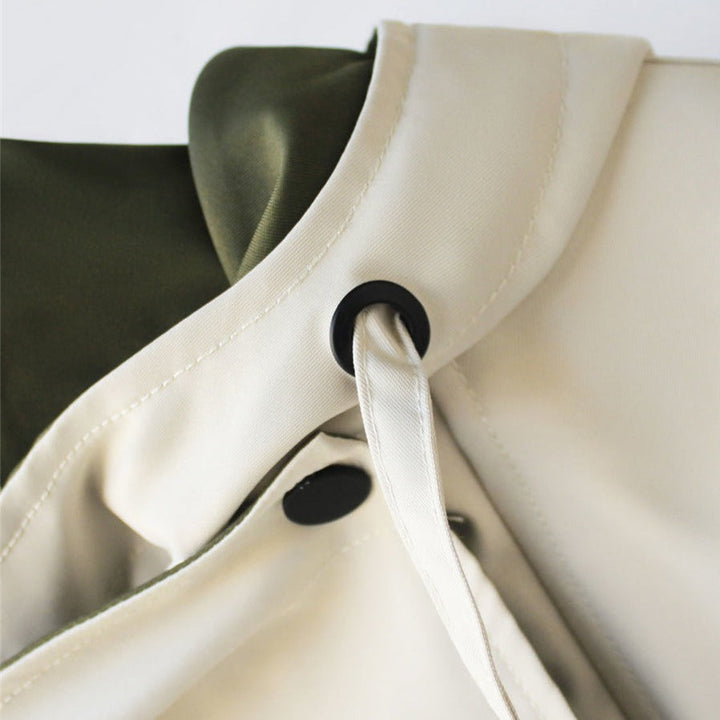 Weatherproof women's rain jacket, waterproof and hooded, ideal lightweight outerwear for protection.