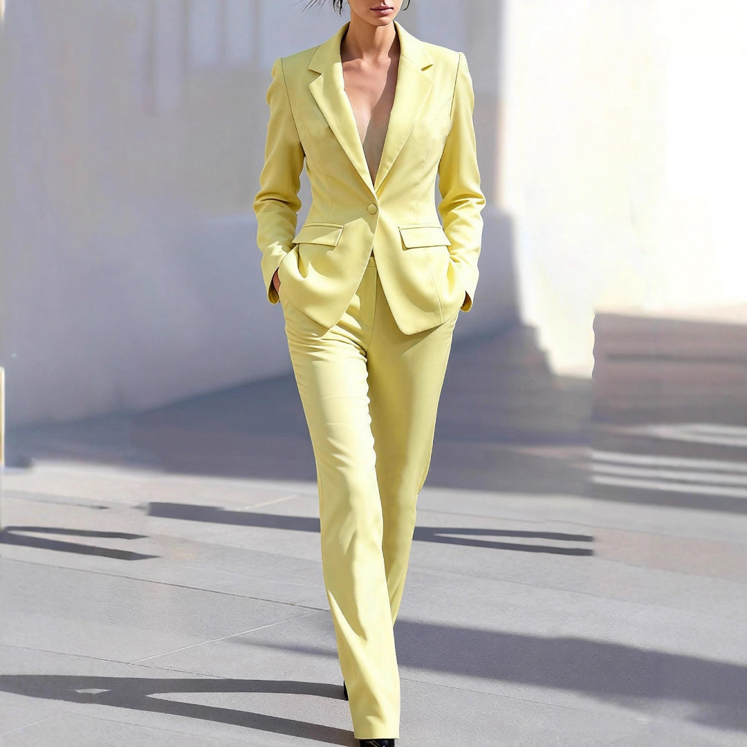 Women's tailored yellow two-piece suit: a stylish blazer & trousers set for professional workwear attire.