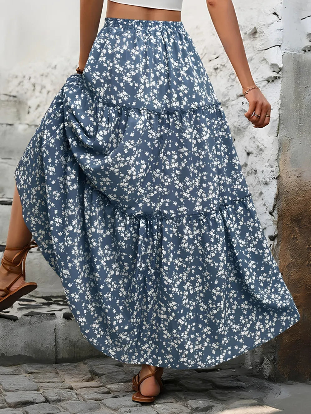 Flowy tiered maxi skirt for women, featuring a vibrant floral print. Bohemian summer style, elegant and feminine.