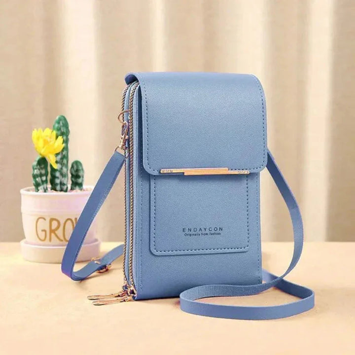 Compact women's phone bag, designed as a touch screen crossbody purse for easy access to your tech & cards.