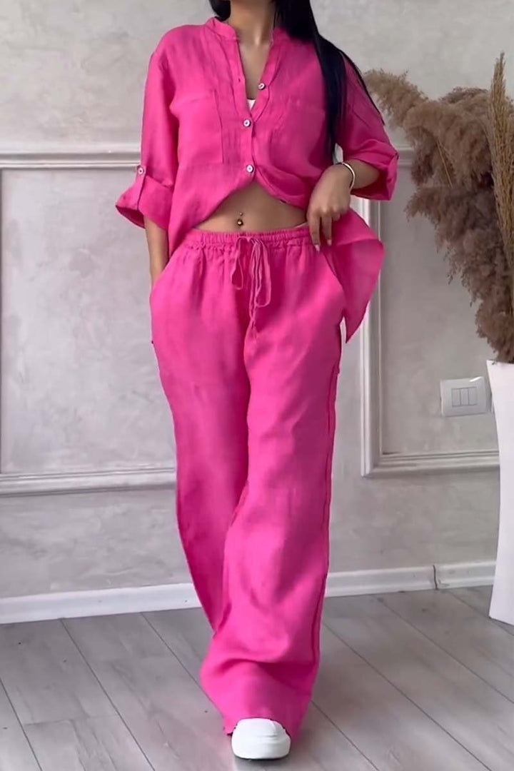 Lightweight women's linen two-piece set for a chic summer outfit, includes a blouse and wide-leg pants.