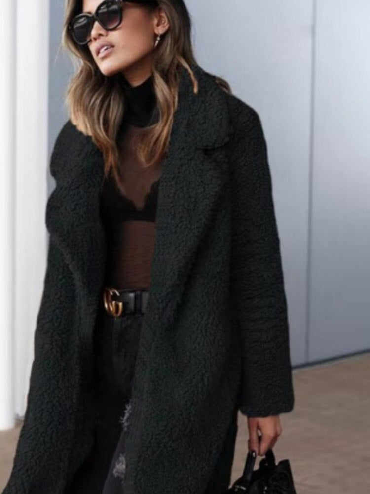 Fashionable long teddy coat for women, a stylish & warm winter outerwear essential.