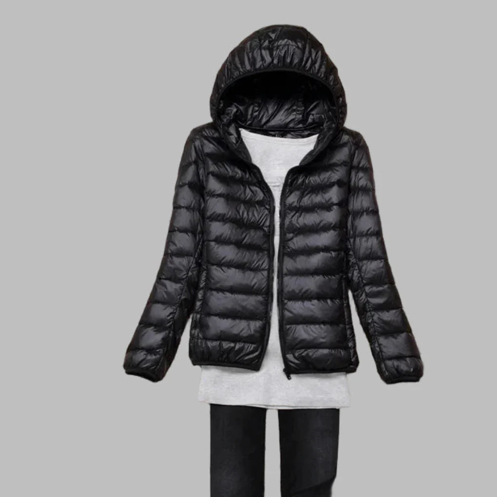 Women's ultra-light packable hooded winter coat, ideal for travel. Lightweight outdoor jacket offering warmth & versatility.