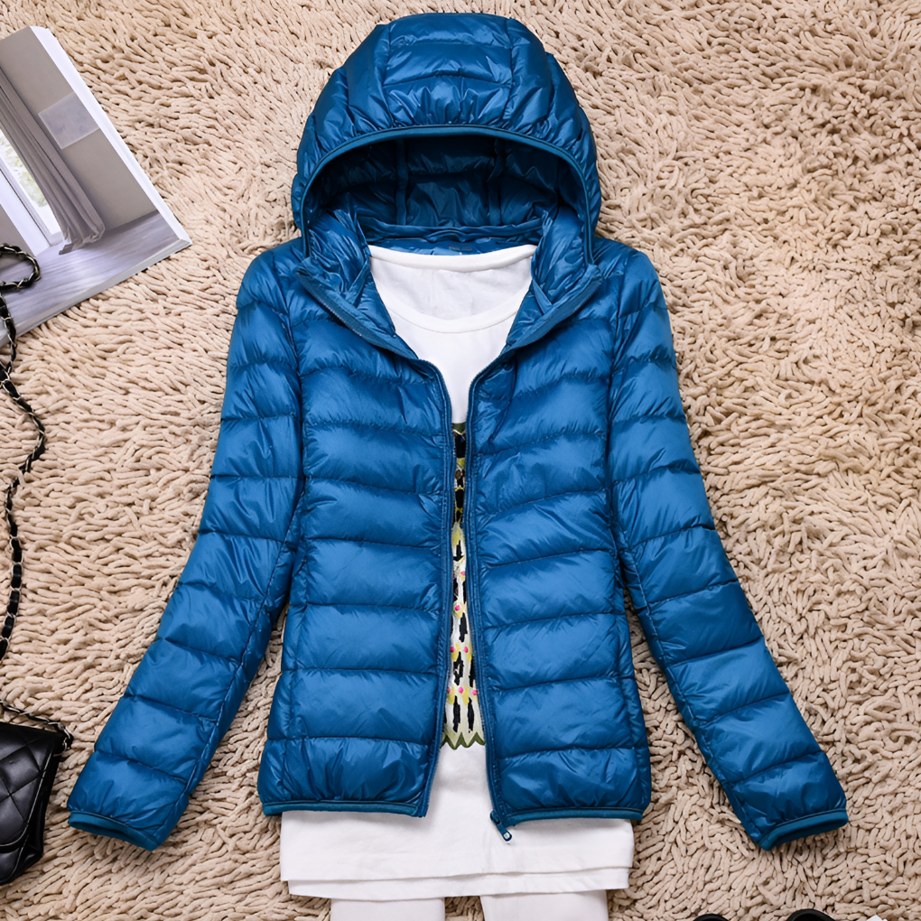 Warm women's hooded winter coat. Lightweight & packable, this versatile outdoor jacket provides essential warmth.