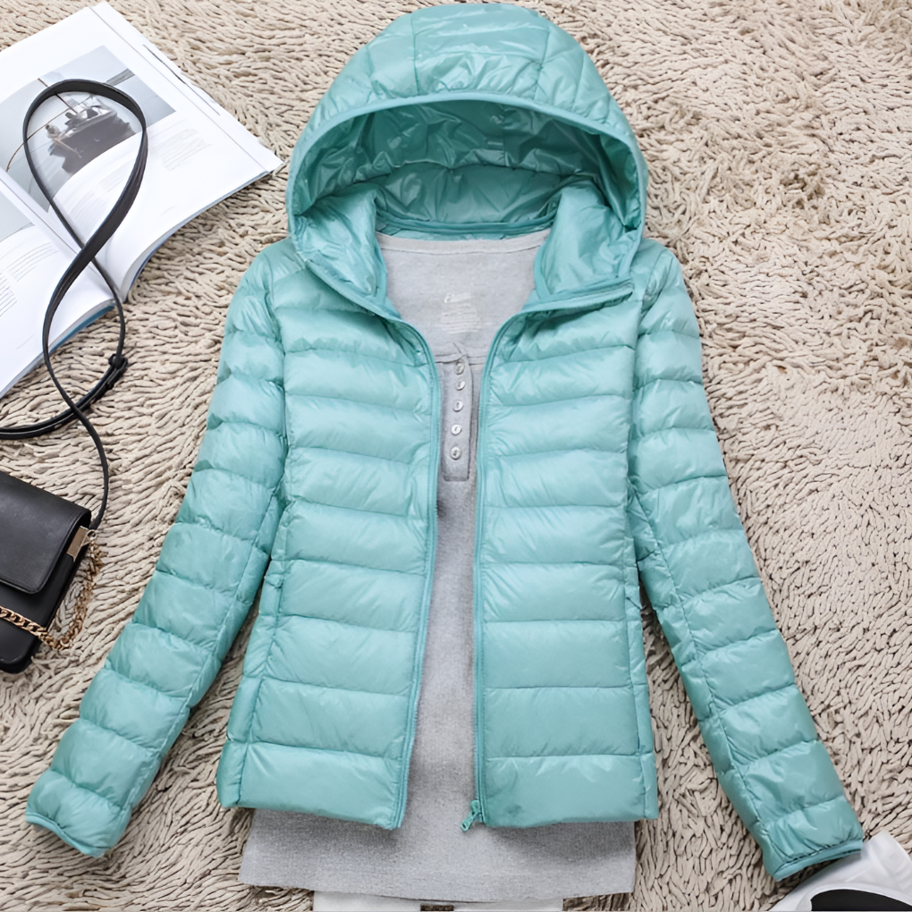 Versatile women's packable hooded jacket for all seasons. Lightweight outdoor coat offering warmth for winter travel.