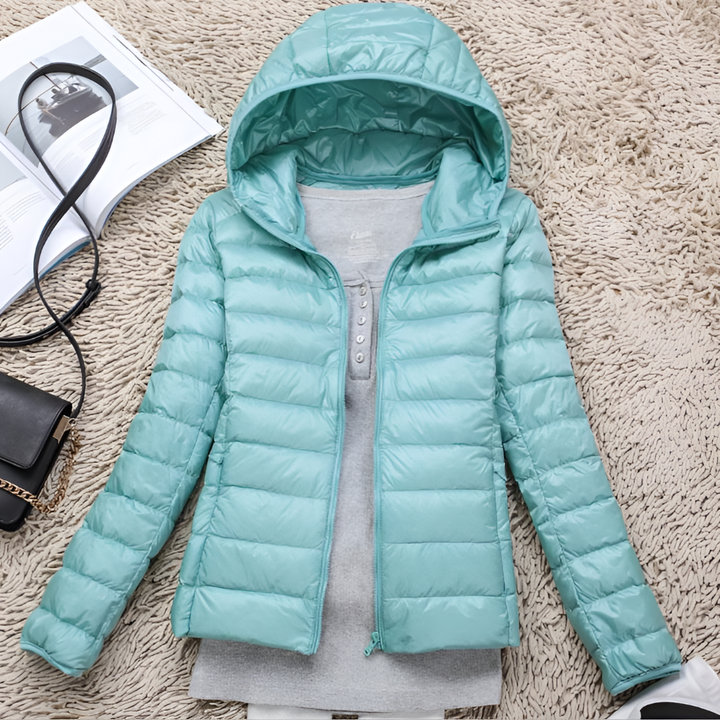Versatile women's packable hooded jacket for all seasons. Lightweight outdoor coat offering warmth for winter travel.