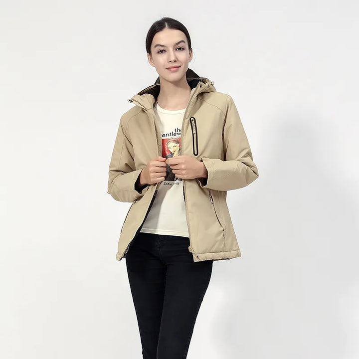 A versatile women's cold weather jacket, featuring a hood, zip closure, and efficient USB heating.