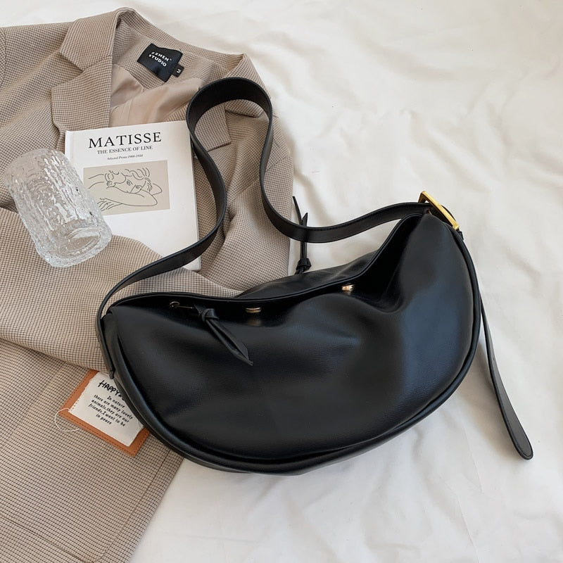 Women's versatile black crossbody bag with adjustable strap, perfect for everyday use or as a minimalist accessory.