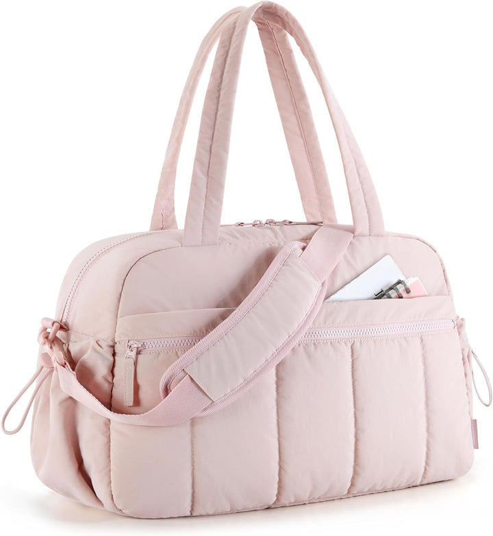 Pink duffle bag for women, a versatile carryall for gym, travel, or work. Features a spacious pocket. Stylish shoulder bag.