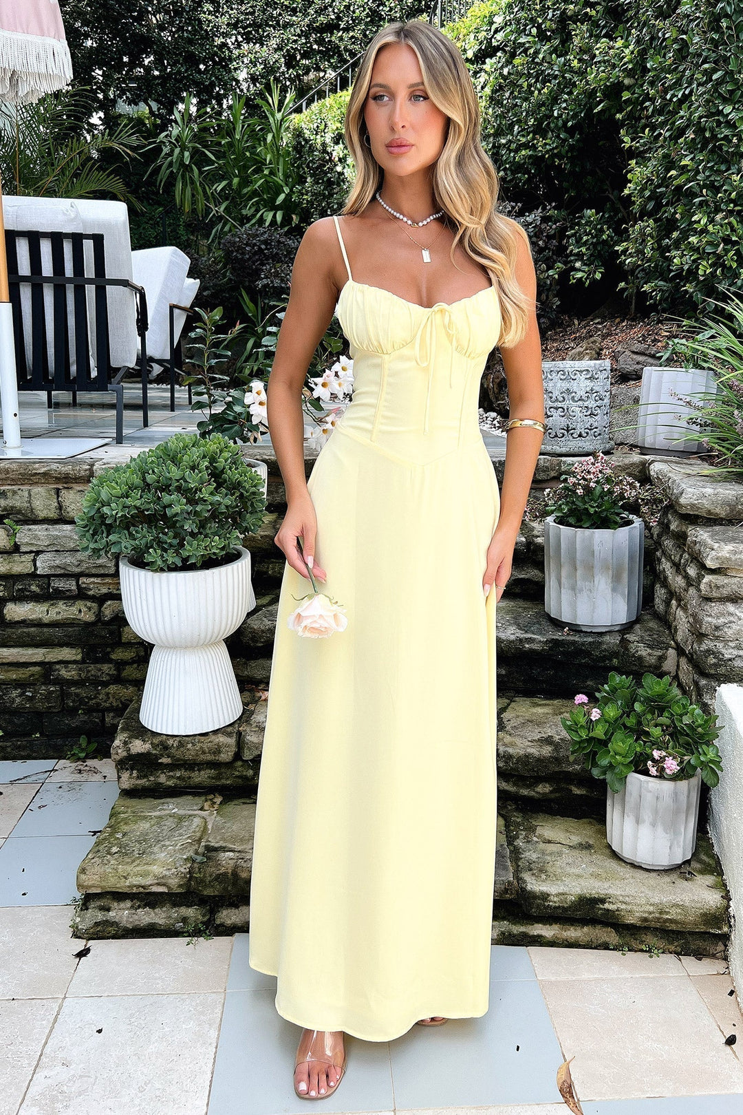 Women's vibrant yellow maxi dress, sleeveless for effortless summer style. Ideal for beach, vacation, or casual wear.