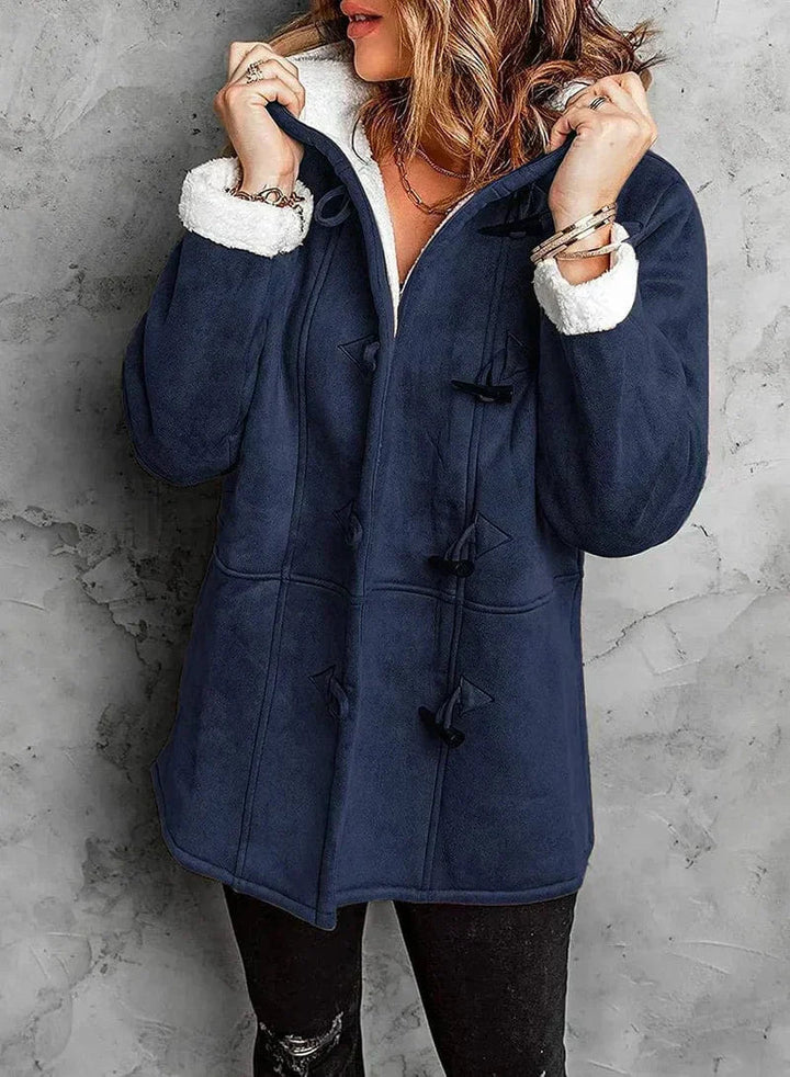Versatile women's hooded winter coat, offering cozy comfort and warmth for various cold weather activities.