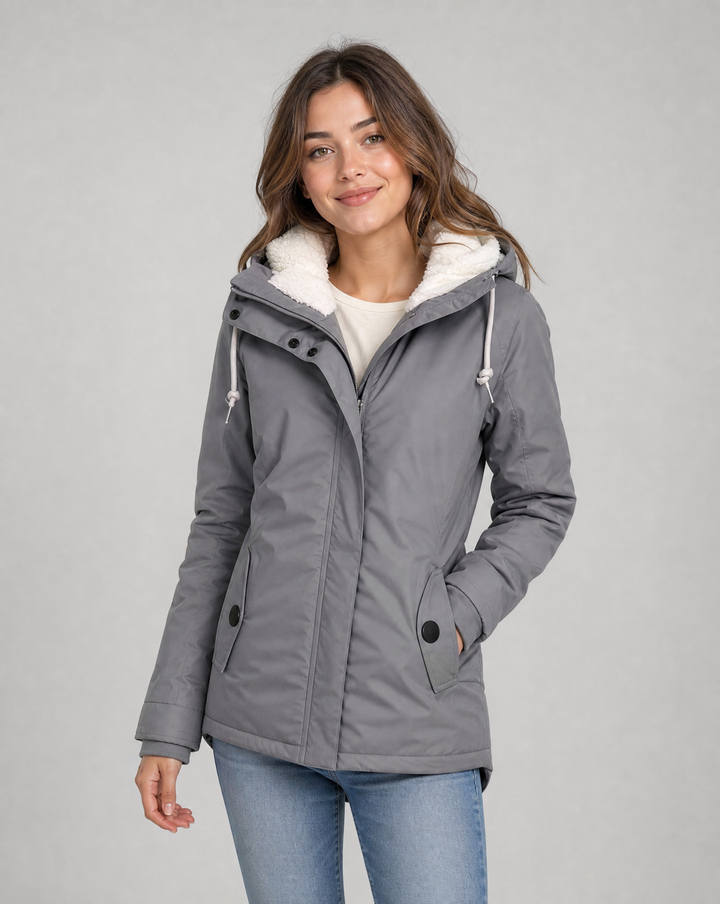 Durable women's rain jacket, fully waterproof with a comfortable hood for outdoor adventures.