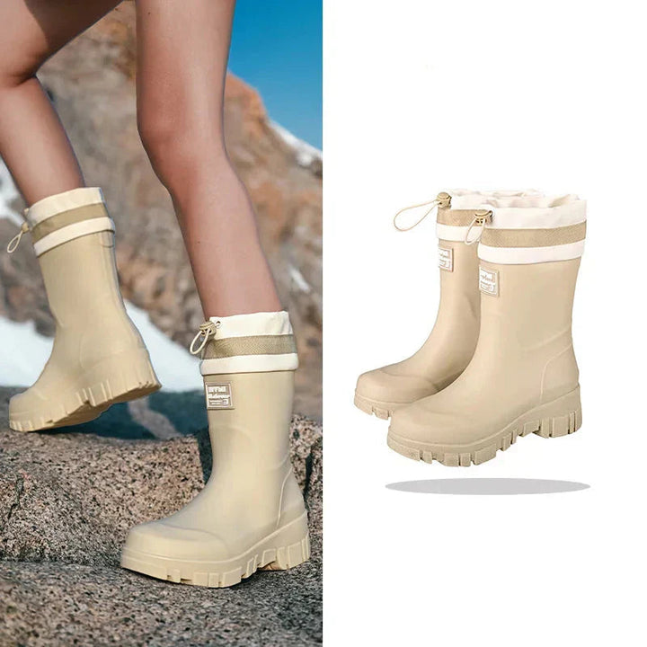 Stylish women's black waterproof ankle rain boots for outdoor activities.