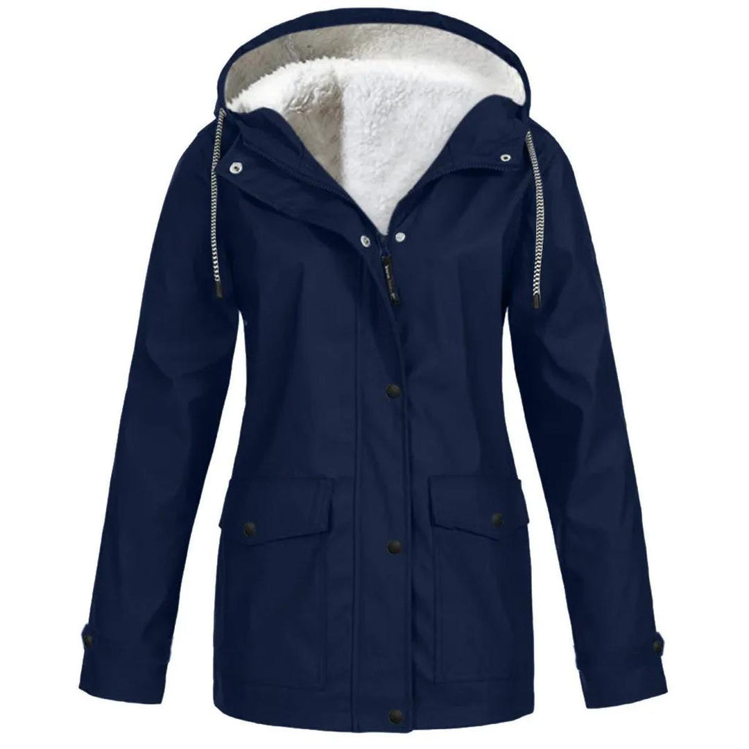 Woman wearing a women's water & windproof insulated jacket with hood, enjoying a brisk outdoor walk.