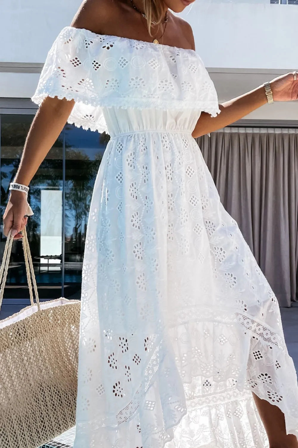 Front view of a white lace off-shoulder high-low dress, ruffled hem, perfect for summer wedding guests.