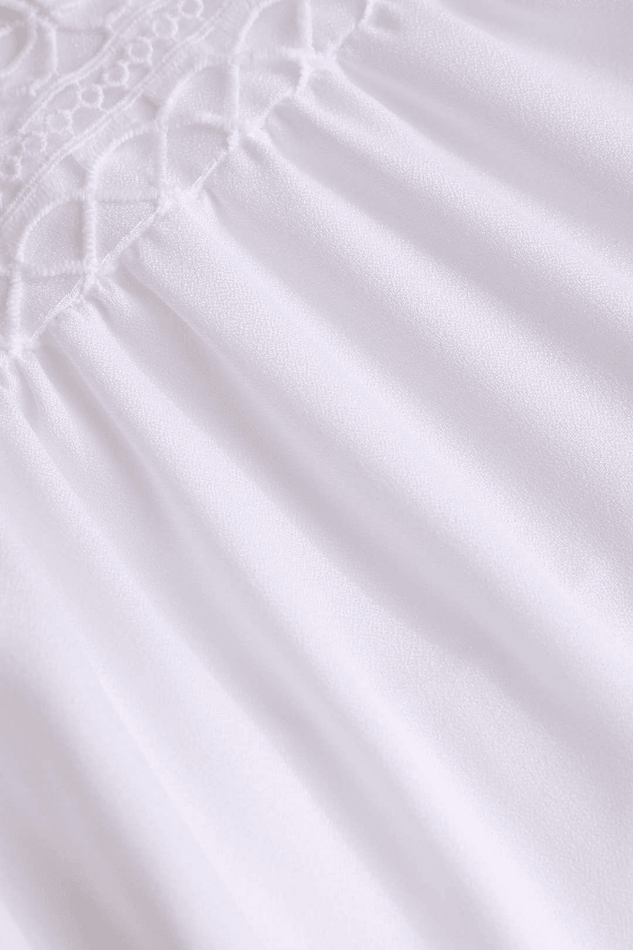 Casual white mini dress with ruffles & V-neck, a stylish sleeveless summer vacation outfit for women.