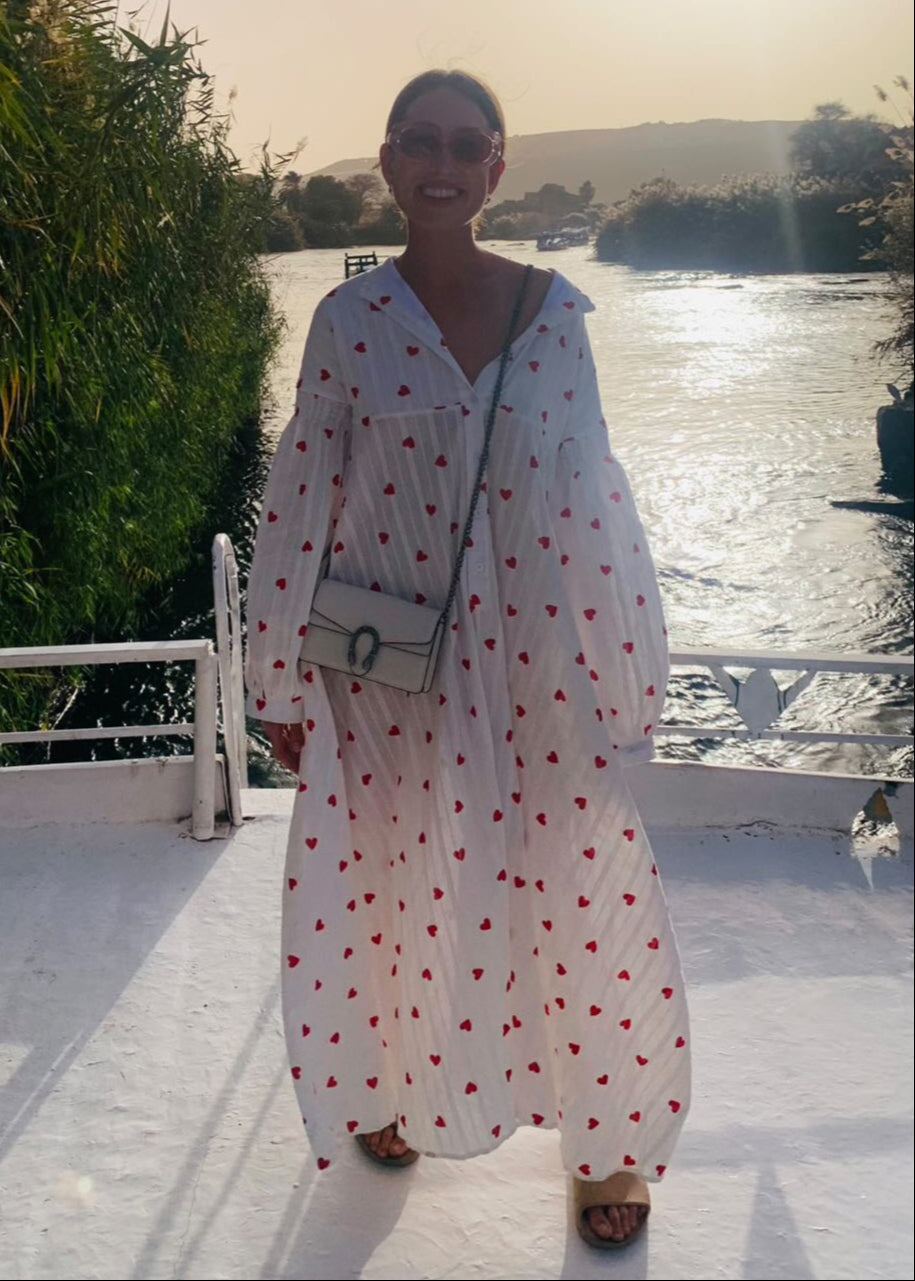 Casual women's oversized white maxi dress with delicate heart embroidery, perfect for day wear.
