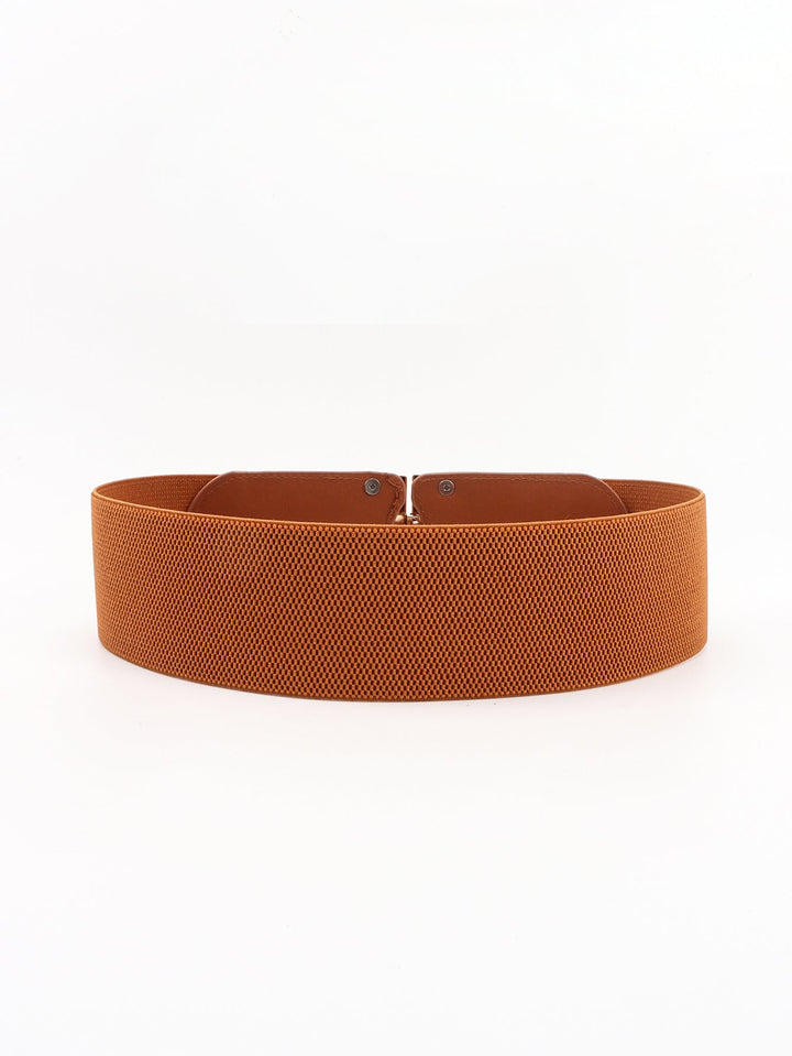 Women's broad stretchy dress belt with an eye-catching buckle, creating a flattering silhouette.