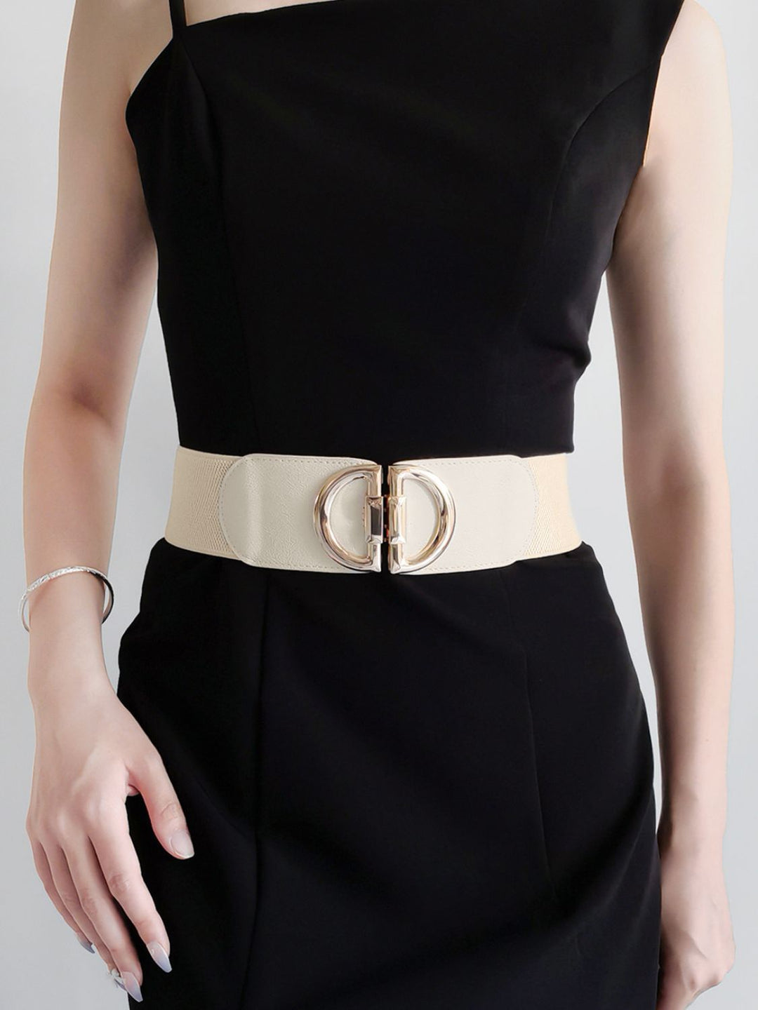 Chic women's wide stretch accessory belt, showcasing a polished buckle, for a defined waistline.
