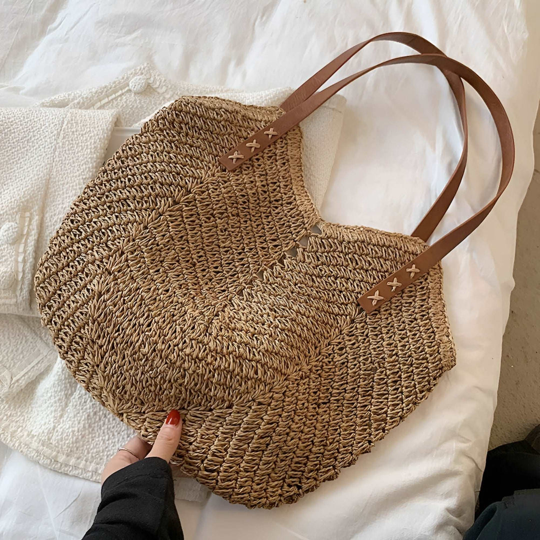 Women's brown woven beach tote, a stylish shoulder bag perfect for summer, vacation, and trips to the beach.
