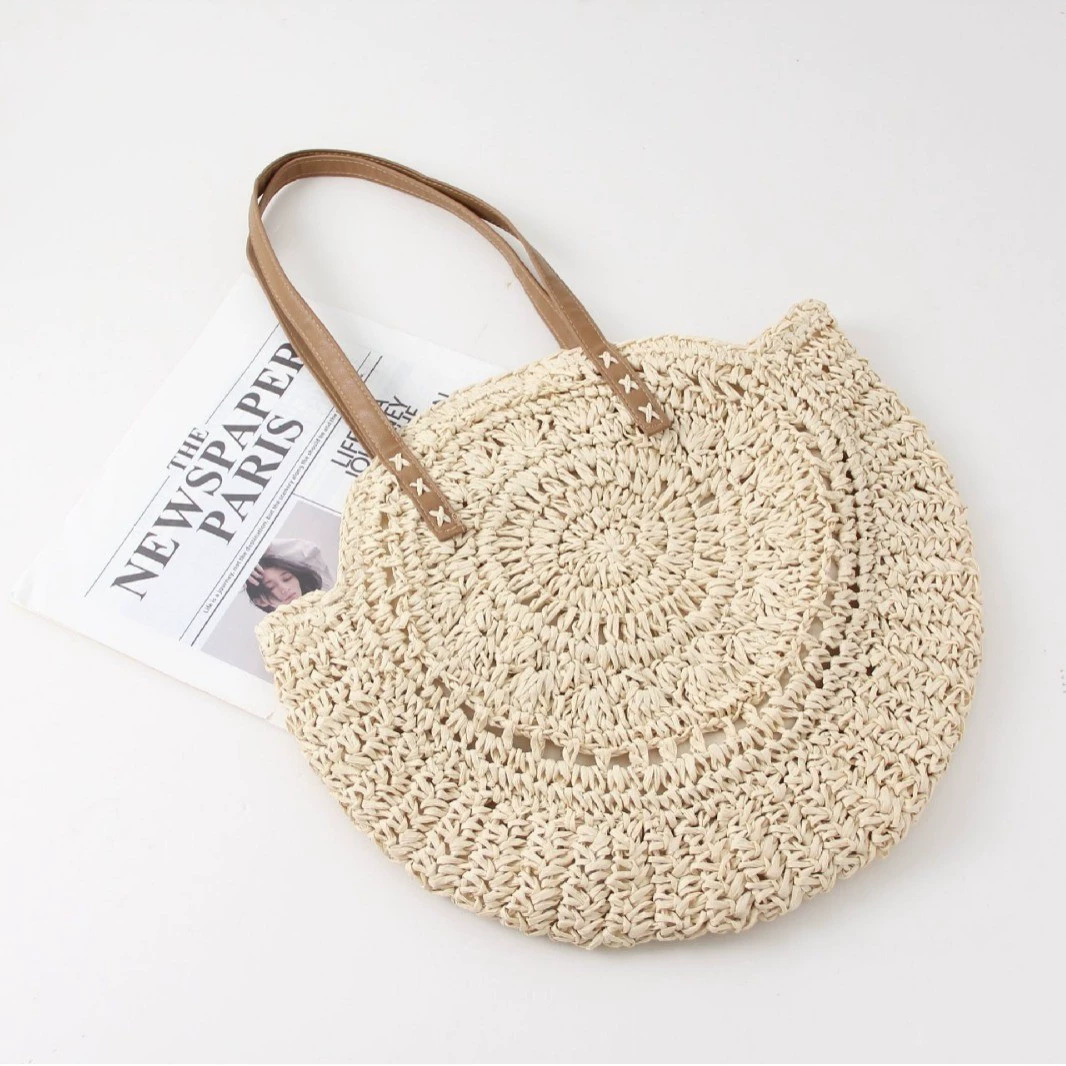 Women's woven round beach tote bag, perfect for summer. Natural fiber shoulder handbag with a casual, bohemian style.