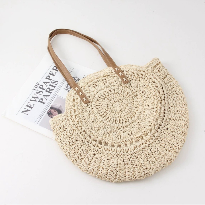 Women's woven round beach tote bag, perfect for summer. Natural fiber shoulder handbag with a casual, bohemian style.