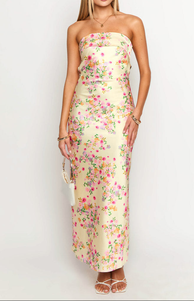 Vibrant yellow floral pattern on a women's strapless summer maxi dress, great for parties.