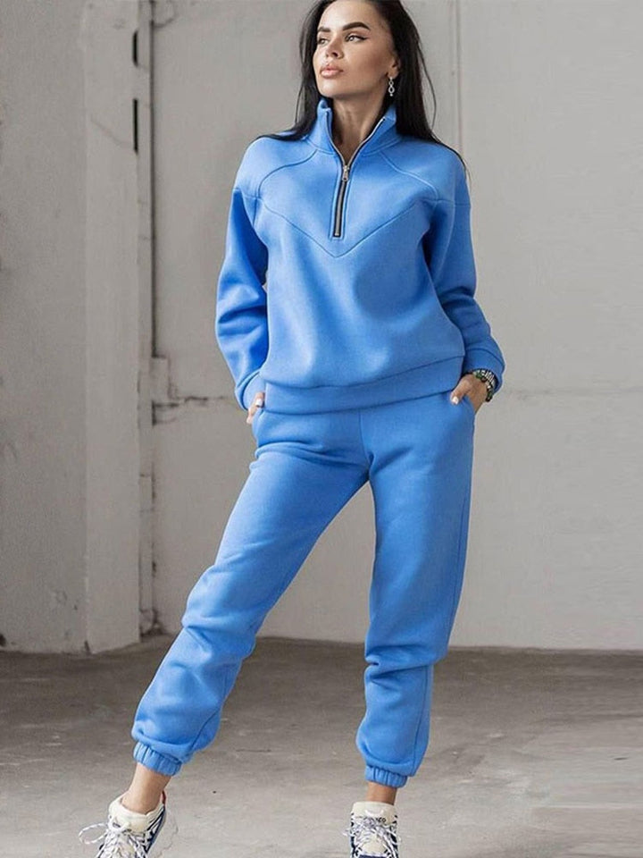 Comfy women's loungewear tracksuit set with stylish zip neck top & soft matching pants. Ideal for relaxing.