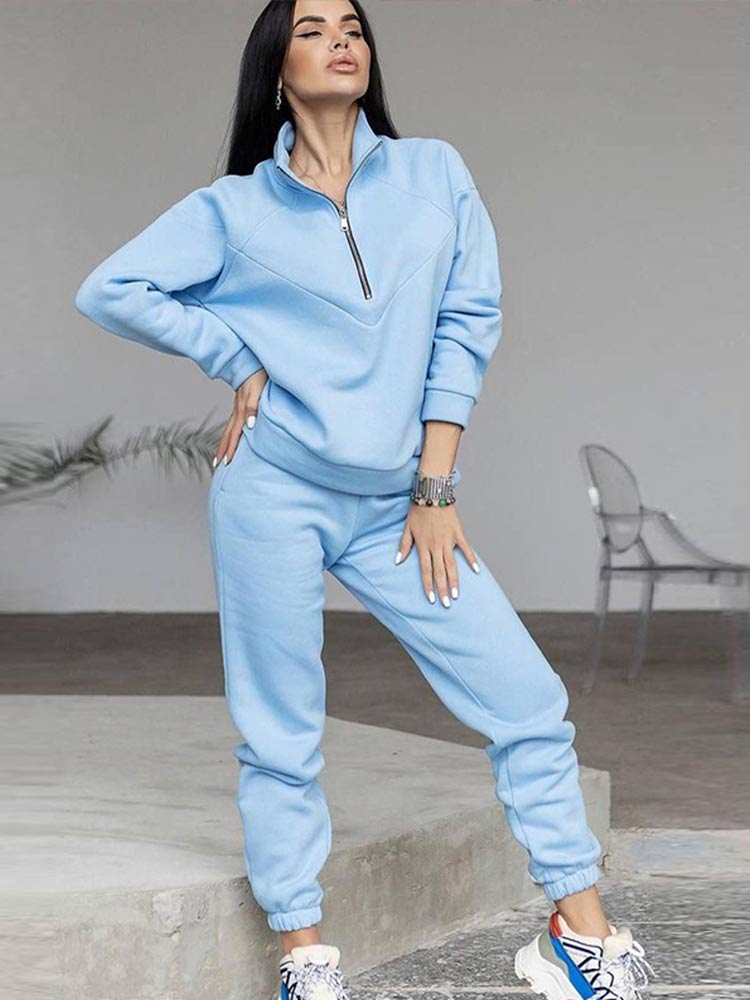 Versatile women's two-piece tracksuit set with a modern zip neck top & comfy matching pants. Great for casual style.
