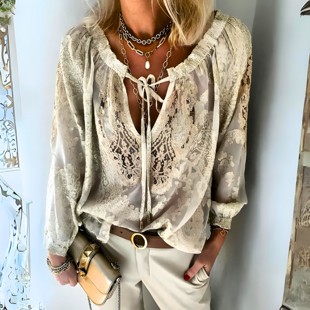 Women's Bohemian crochet blouse with relaxed fit, intricate crochet design, long sleeves, and drawstring neckline.
