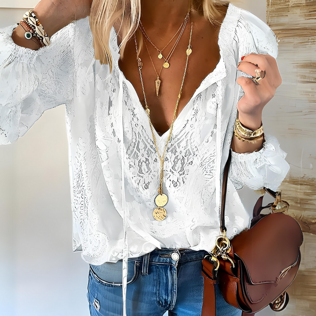 Women's Bohemian crochet blouse with relaxed fit, intricate crochet design, long sleeves, and drawstring neckline.