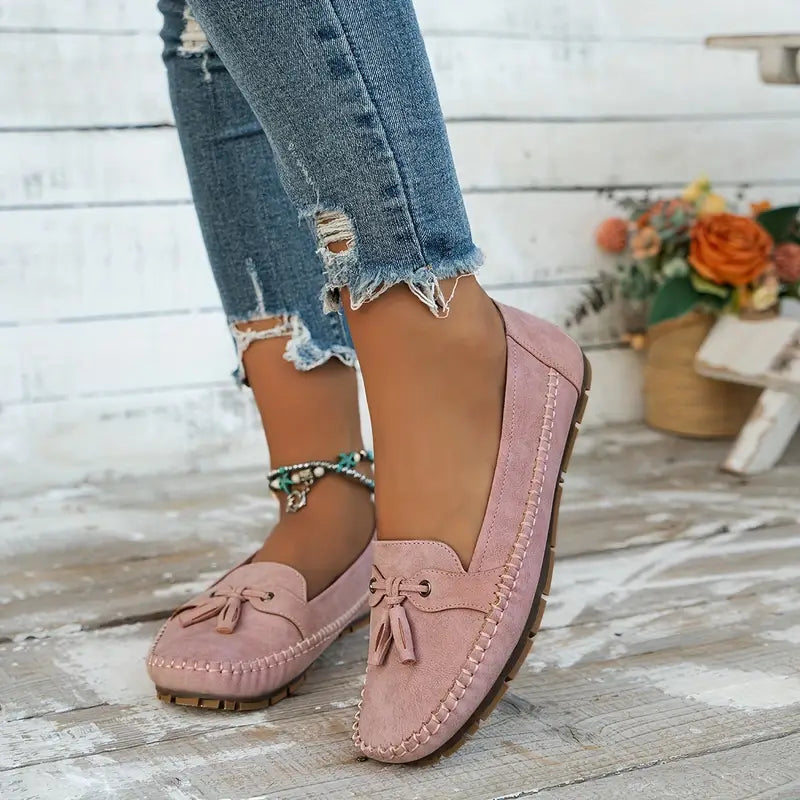 "Women's classic bow loafers in soft suede, stylish flat slip-ons with elegant bow accent, ideal for any occasion."
