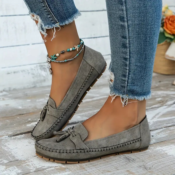 "Women's classic bow loafers in soft suede, stylish flat slip-ons with elegant bow accent, ideal for any occasion."