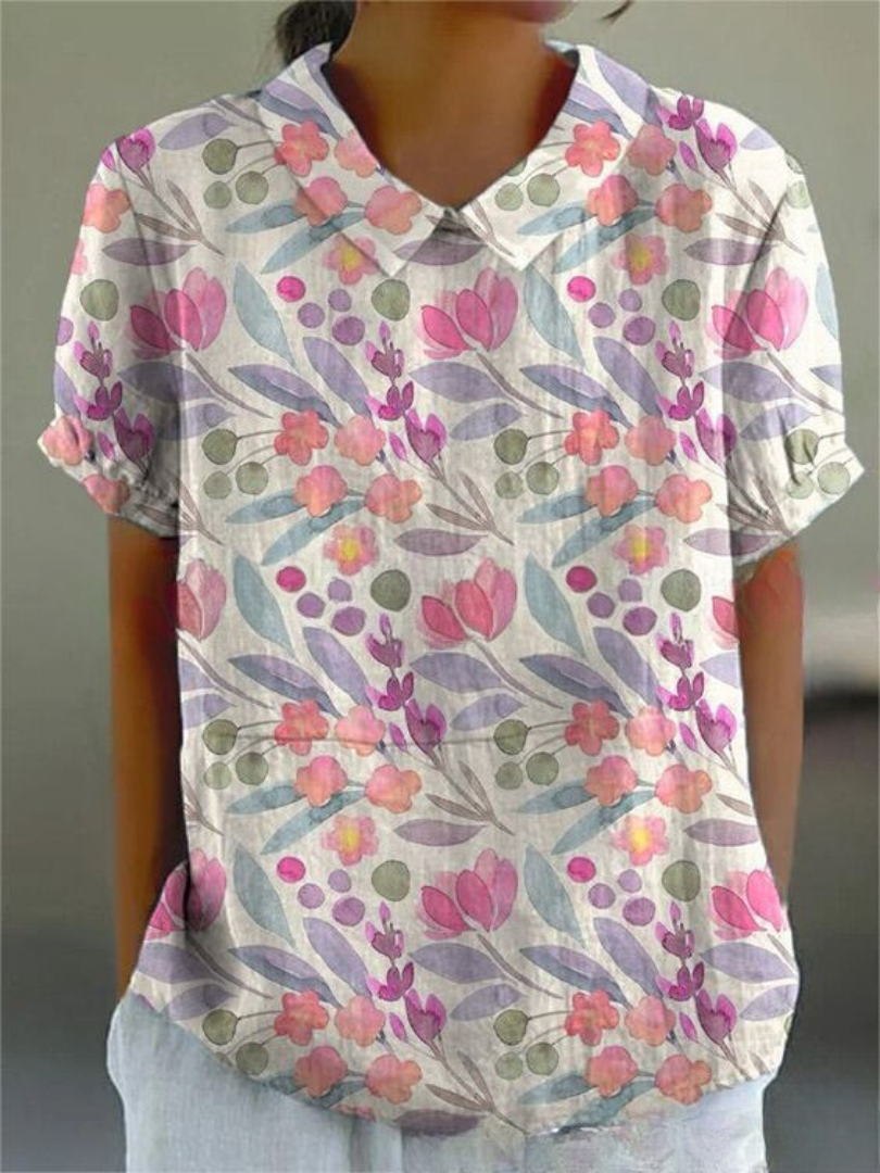 Women's elegant floral blouse with short sleeves and Peter Pan collar, featuring a vibrant floral pattern for stylish summer 
