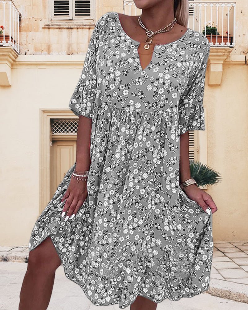 Women's elegant floral V-neck midi dress, vibrant pattern, flattering fit, perfect for garden parties and casual outings.