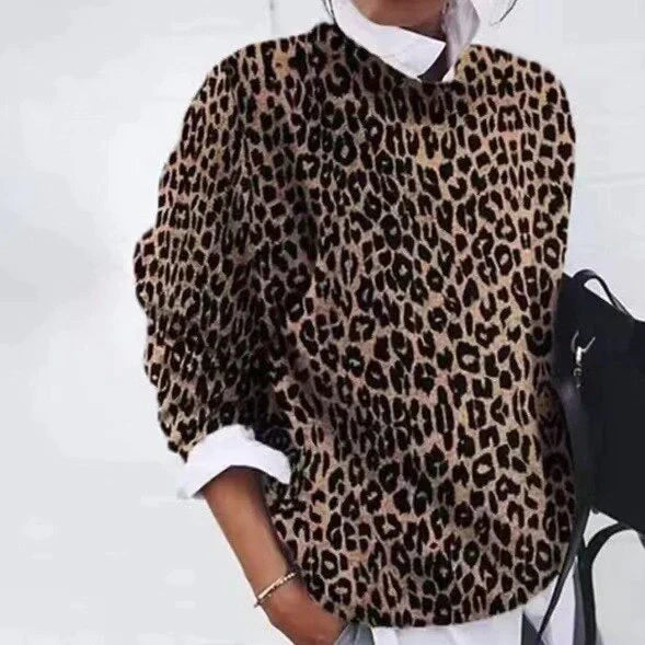 Close-up of women's vibrant retro sweater showcasing intricate floral and geometric designs.