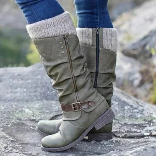Women's knee-high boots with chic buckle, cozy knit cuff, side zipper, textured sole, and round toe in synthetic suede.
