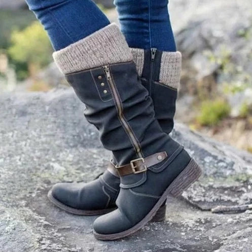Women's knee-high boots with chic buckle, cozy knit cuff, side zipper, textured sole, and round toe in synthetic suede.