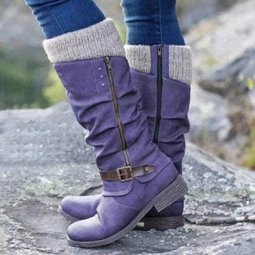 Women's knee-high boots with chic buckle, cozy knit cuff, side zipper, textured sole, and round toe in synthetic suede.