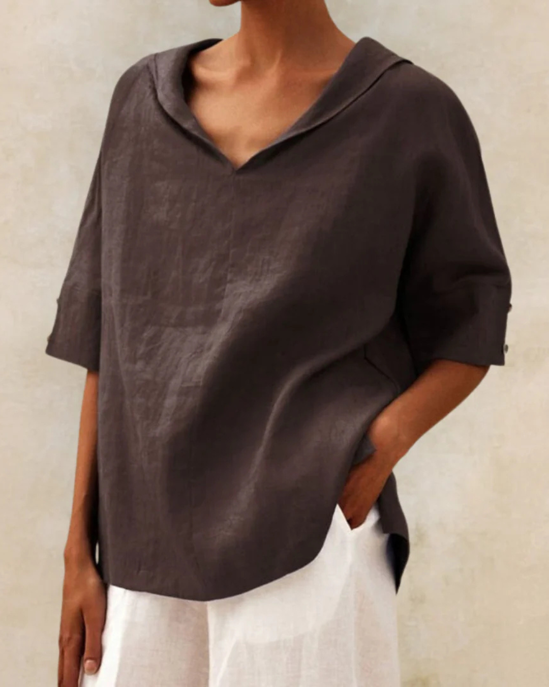 "Women's linen blouse with V-neck and half sleeves, lightweight fabric, chic design, ideal for spring and summer wear."