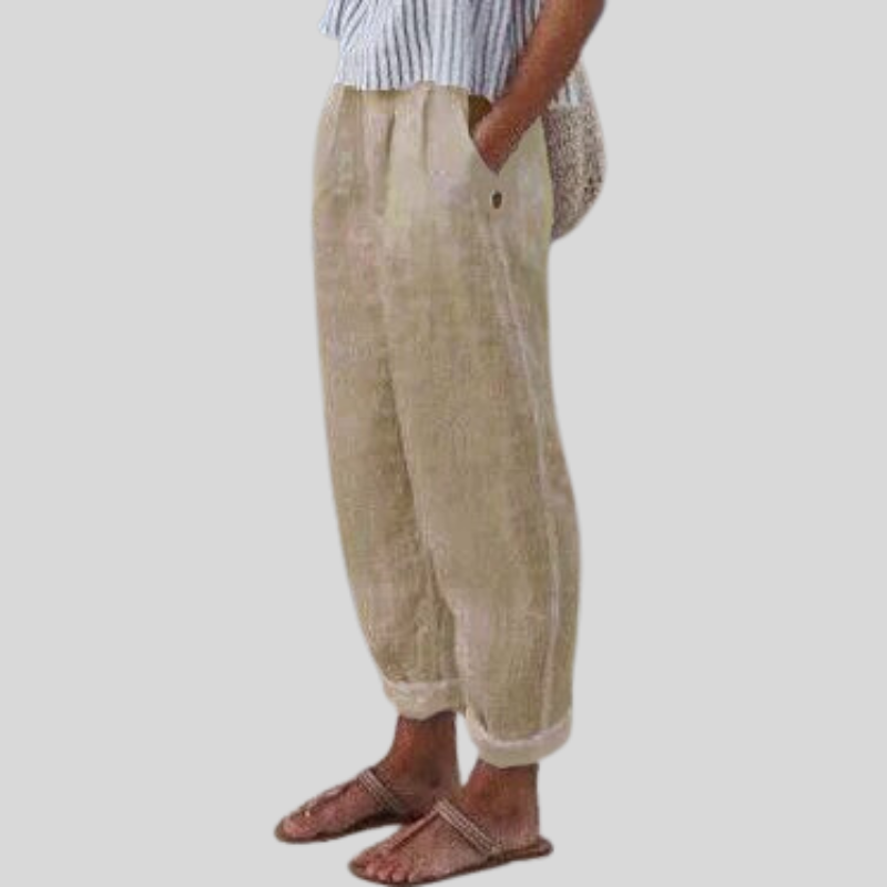 "Women's linen trousers with folded hem, relaxed fit; lightweight, breathable fabric, beige tones, tailored style."