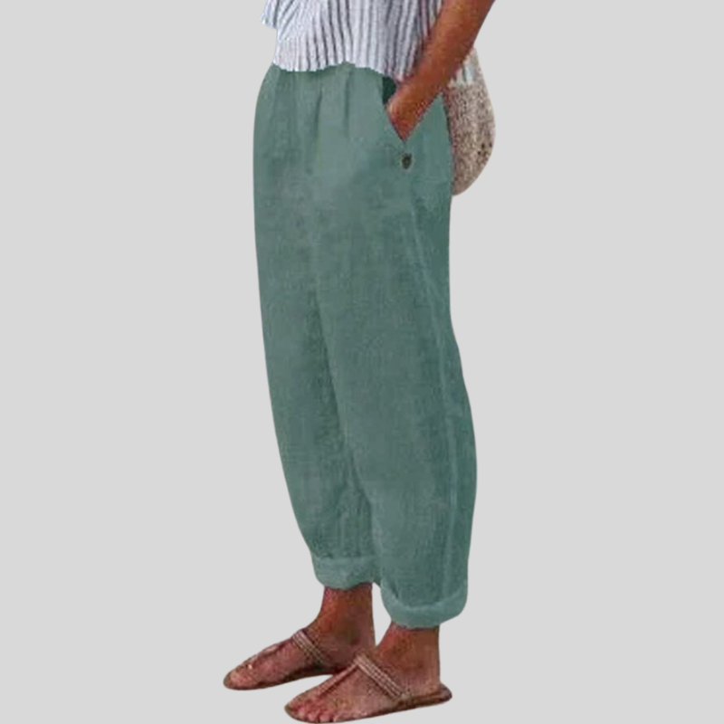 "Women's linen trousers with folded hem, relaxed fit; lightweight, breathable fabric, beige tones, tailored style."
