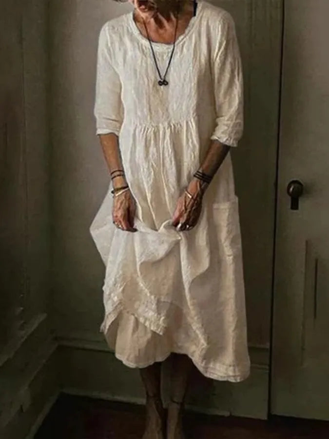 "Women's Loose Fit Cotton Linen Midi Dress with round neck, 3/4 sleeves, asymmetric hem, and pockets in various colors."