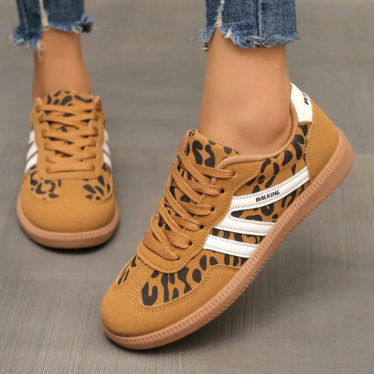"Women's modern low-top lace-up sneakers with chic side stripes, perfect for casual attire and sporty wear."