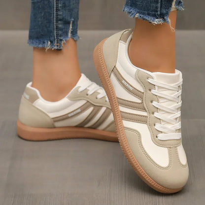 "Women's modern low-top lace-up sneakers with chic side stripes, perfect for casual attire and sporty wear."